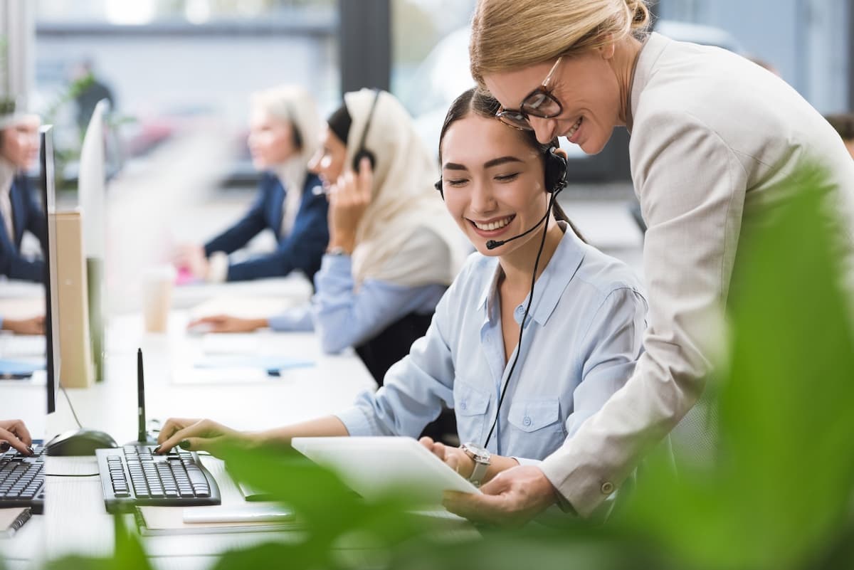 A call centre manager reviews data with a worker