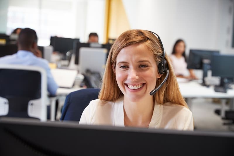 A smiling call centre operator at work