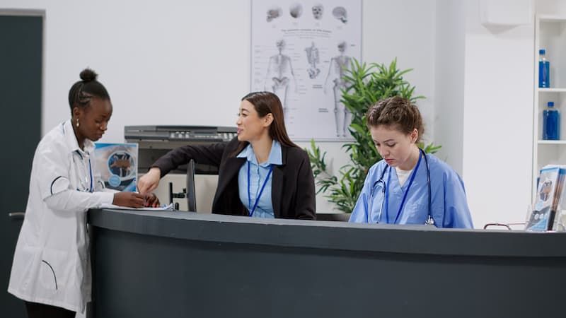 Admin clinic worker and nurses at the reception desk