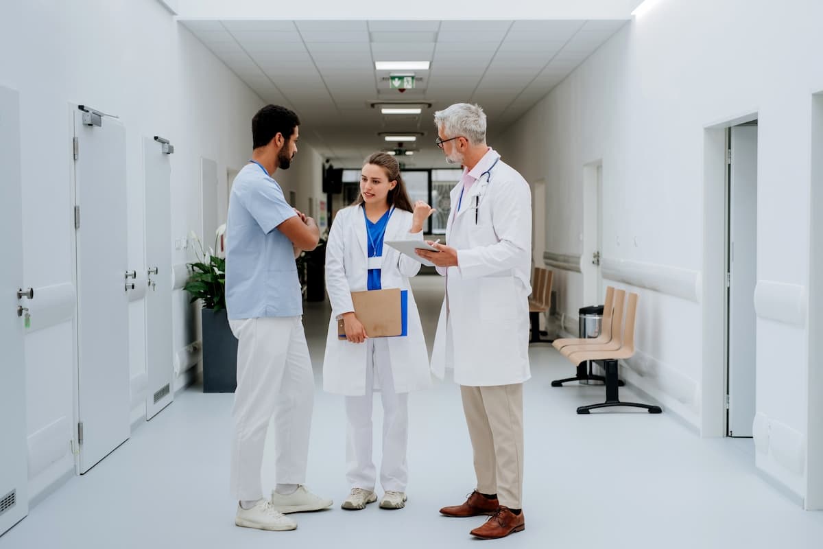 A group of doctors and nurses discussing in a hospital's corridor