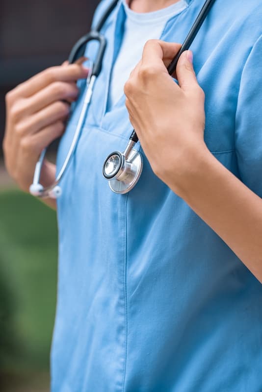 Details of a female doctor wearing a stetoscope