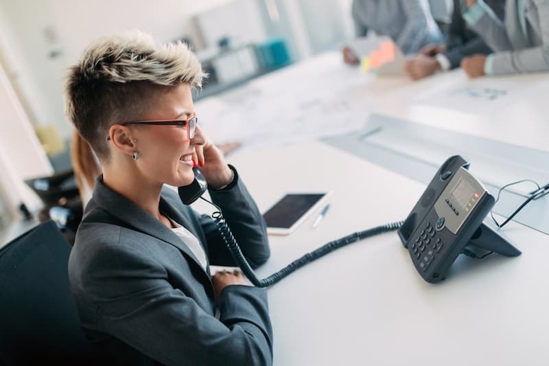 Office receptionist on the phone in a meeting room