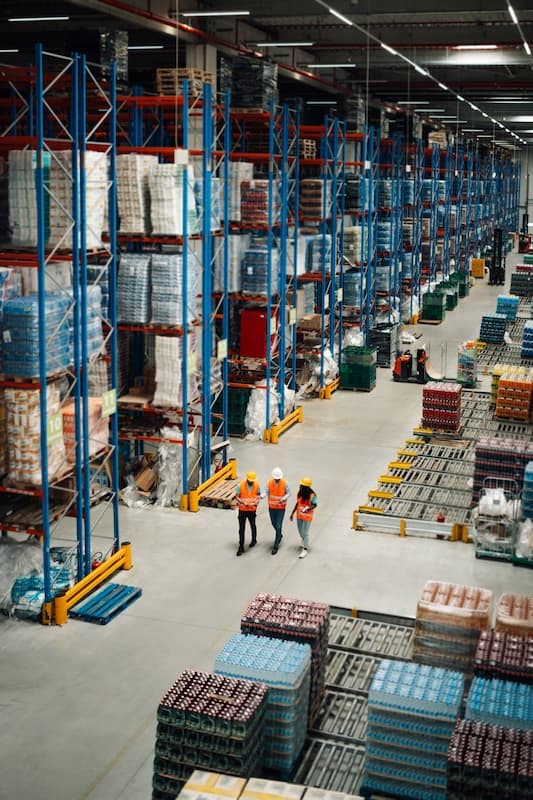 Large warehouse with workers walking through and talking