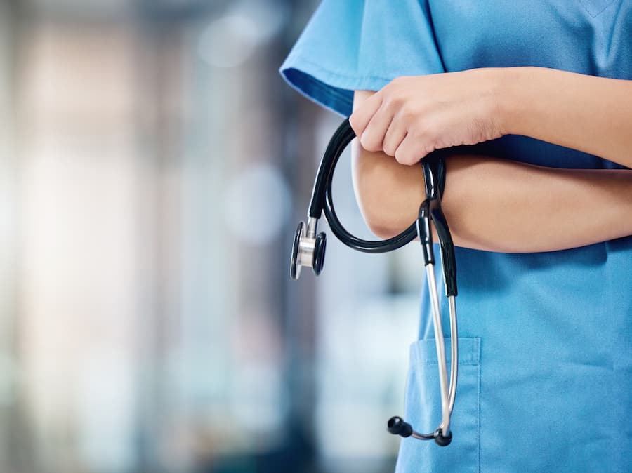 Doctor holding a stethoscope at a hospital.