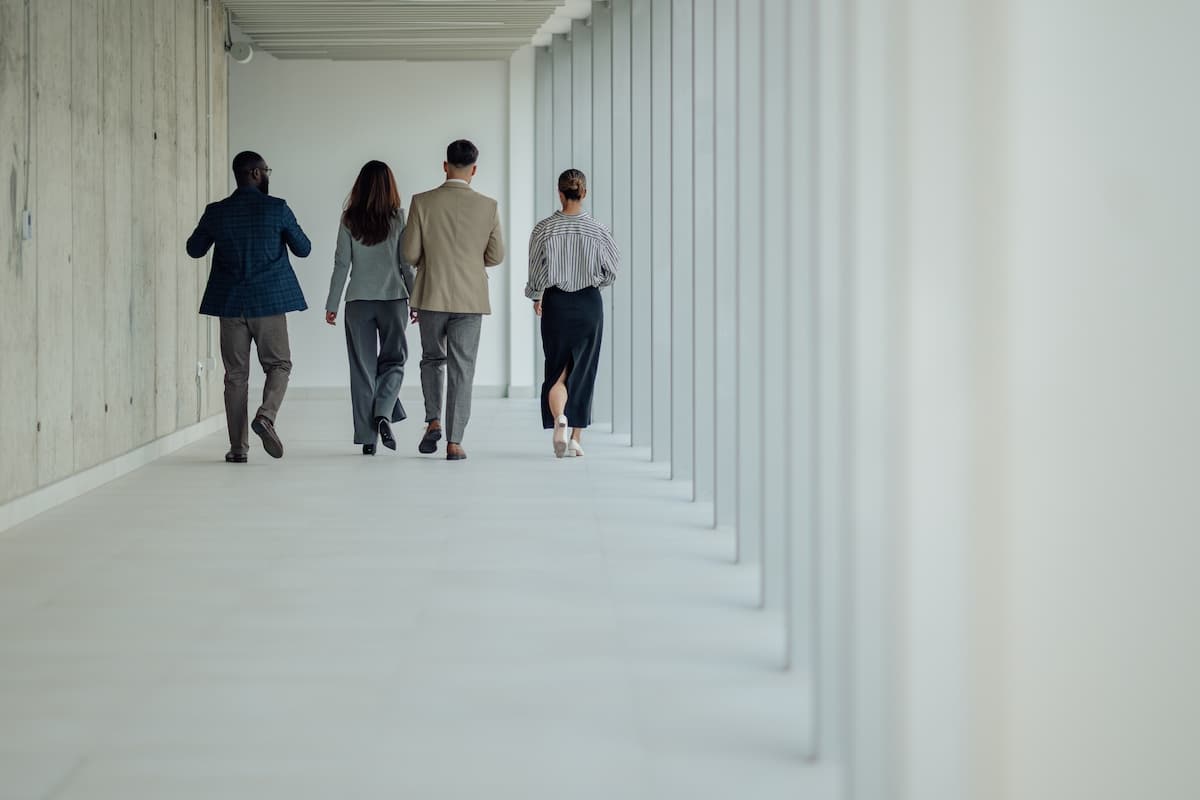 A team of business people walking through a modern building