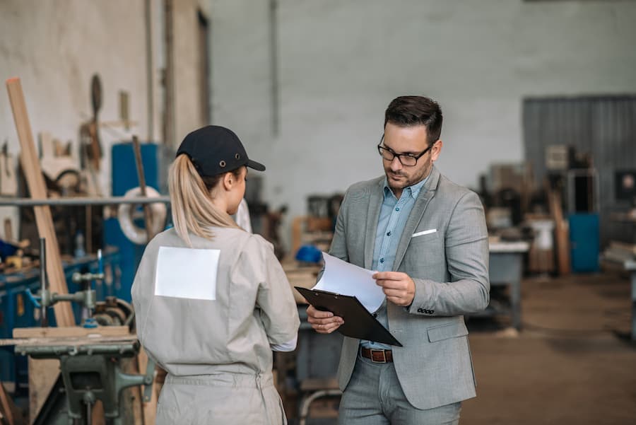Manager looking at documents with a female worker