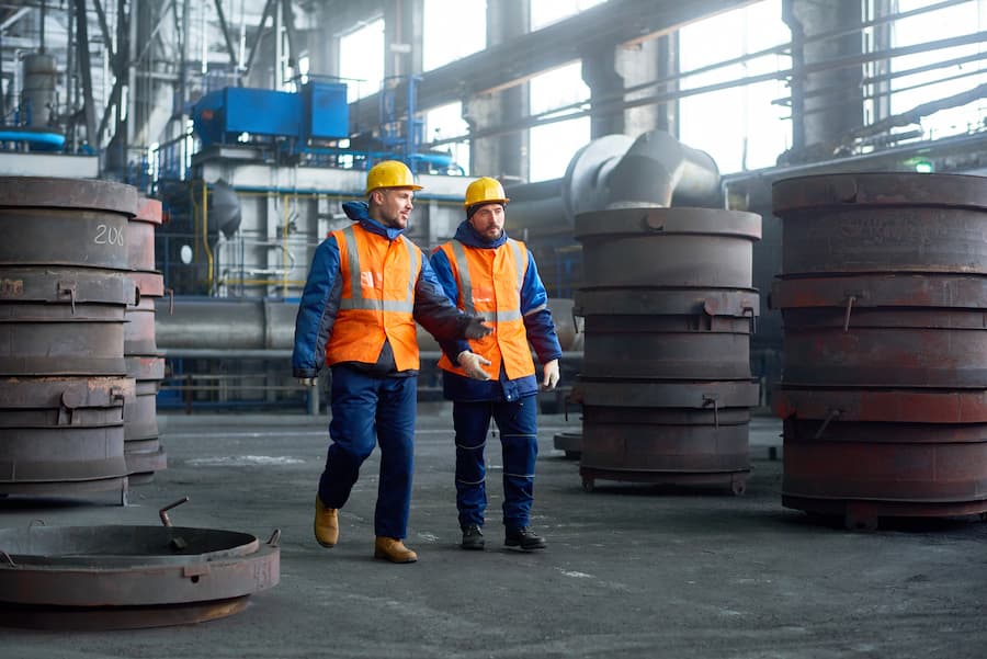 Two Technicians Walking Along Production Department